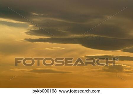 Stock Photo - Sky with clouds at sunset. Fotosearch