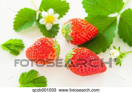 Stock Image - Strawberries and green leaves. Fotosearch