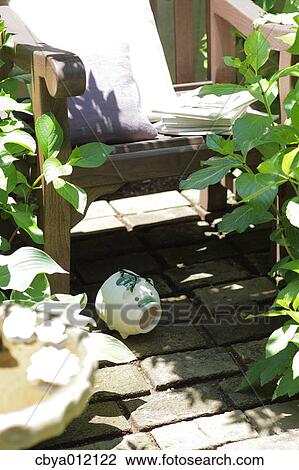 Stock Image - Deck chair in a garden. Fotosearch