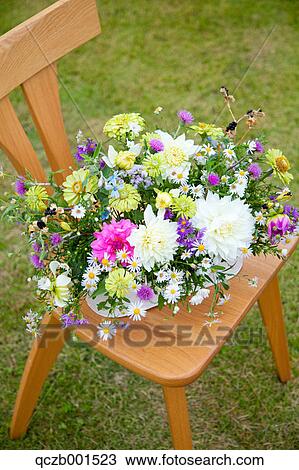 Flower bouquet on wooden chair View Large Photo Image Stock Image - Flower bouquet on wooden chair. Fotosearch