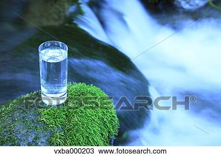 Glass of water near a mountain stream View Large Photo Image Stock Image - Glass of water near a mountain stream. Fotosearch