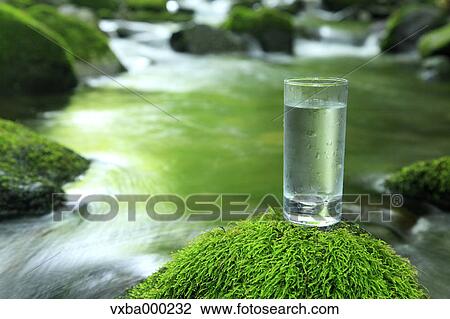 Glass of water near a mountain stream View Large Photo Image Stock Image - Glass of water near a mountain stream. Fotosearch