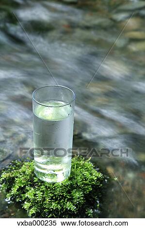 Glass of water near a mountain stream View Large Photo Image Stock Photography - Glass of water near a mountain stream. Fotosearch