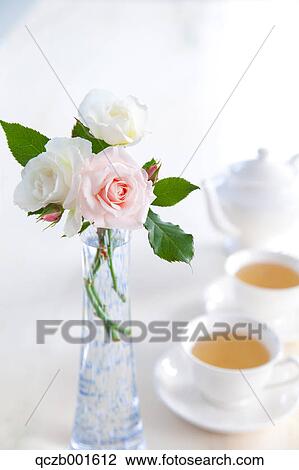 Herbal tea and a roses in a vase View Large Photo Image Stock Image - Herbal tea and a roses in a vase. Fotosearch