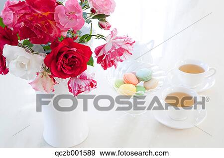 Herbal tea macaroons and roses View Large Photo Image Stock Photo - Herbal tea macaroons and roses. Fotosearch