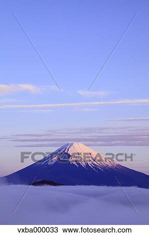 Stock Image - Sea of??clouds and morning glow at Mount Fuji. Fotosearch