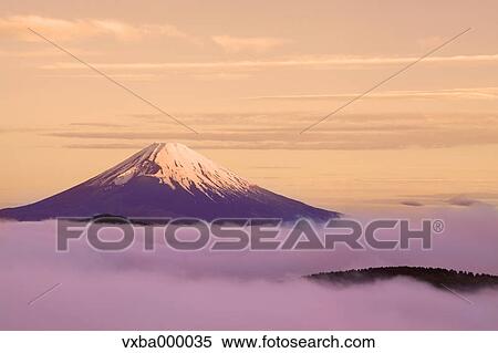Stock Photography - Sea of??clouds and morning glow at Mount Fuji. Fotosearch