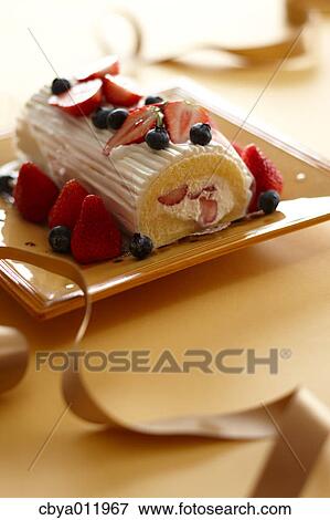Strawberry roll cake and ribbon on a plate View Large Photo Image Stock Photo - Strawberry roll cake and ribbon on a plate. Fotosearch
