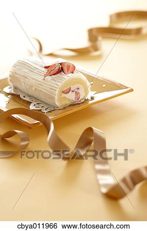 Strawberry roll cake and ribbon on a plate View Large Photo Image Stock Photograph - Strawberry roll cake and ribbon on a plate. Fotosearch