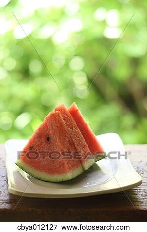 Watermelon on a wooden bench View Large Photo Image Stock Photo - Watermelon on a wooden bench. Fotosearch