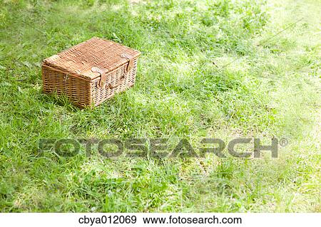 Wooden basket on the grass View Large Photo Image Stock Photo - Wooden basket on the grass. Fotosearch
