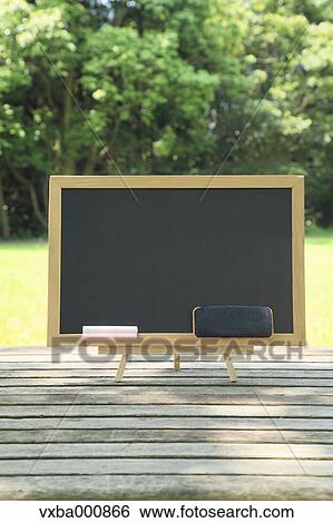 Blackboard placed on wood deck View Large Photo Image Stock Photograph - Blackboard placed on wood deck. Fotosearch