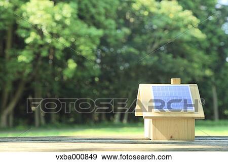 Miniature wooden house with solar panels View Large Photo Image Stock Photo - Miniature wooden house with solar panels. Fotosearch