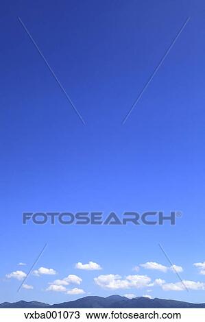 Mountains and blue sky with clouds View Large Photo Image Stock Image - Mountains and blue sky with clouds. Fotosearch