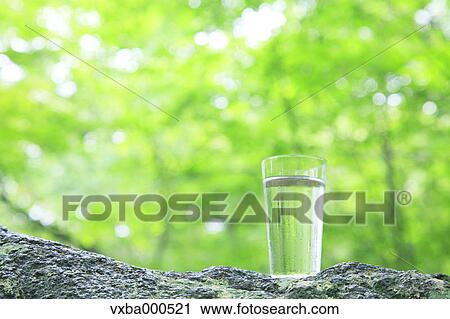 Stock Image - Water glass on a rock. Fotosearch