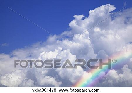 Blue sky with clouds and rainbow View Large Photo Image Stock Photo - Blue sky with clouds and rainbow. Fotosearch