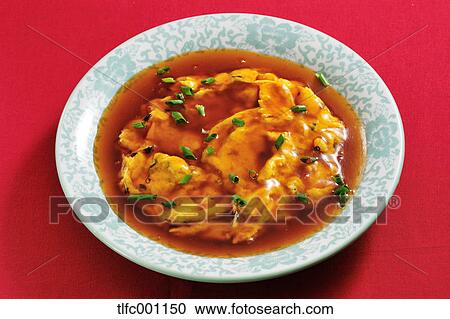 Stock Image - Egg in soup. Fotosearch