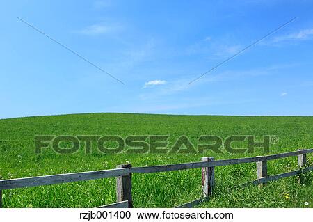 Stock Image - Grassland and blue sky with clouds, Hokkaido. Fotosearch