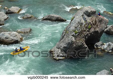 Stock Photography - People canoeing at Tama river. Fotosearch