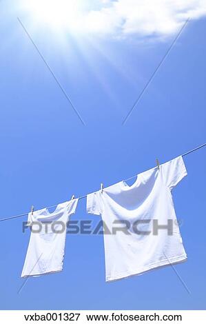 Stock Photo - T-shirts and sky with clouds. Fotosearch