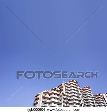 Apartment building and blue sky View Large Photo Image Picture - Apartment building and blue sky. Fotosearch