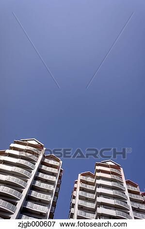 Stock Photo - Apartment buildings and blue sky. Fotosearch