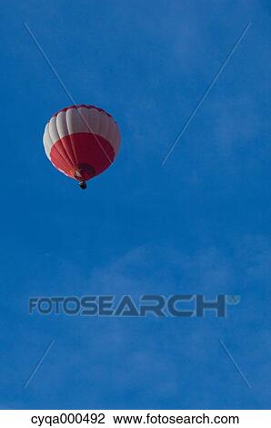 Stock Image - Balloon flying against clear sky, Netherlands. Fotosearch