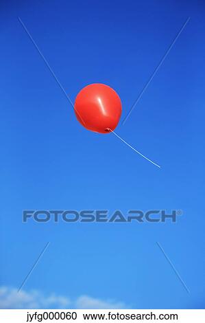 Balloon flying in the blue sky View Large Photo Image Stock Image - Balloon flying in the blue sky. Fotosearch