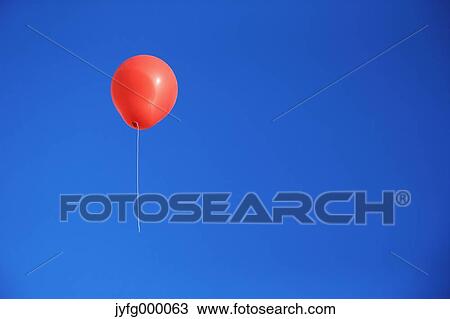 Balloon flying in the blue sky View Large Photo Image Stock Image - Balloon flying in the blue sky. Fotosearch