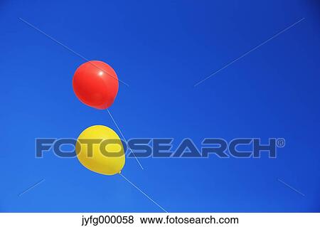 Balloons flying in the blue sky View Large Photo Image Stock Photo - Balloons flying in the blue sky. Fotosearch