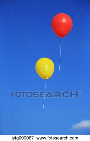 Balloons flying in the blue sky View Large Photo Image Stock Photo - Balloons flying in the blue sky. Fotosearch