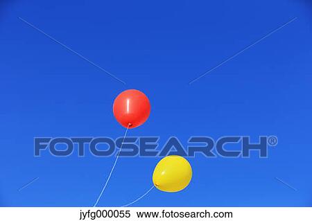 Balloons flying in the blue sky View Large Photo Image Stock Photography - Balloons flying in the blue sky. Fotosearch