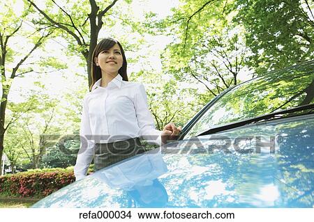 Businesswoman and blue car View Large Photo Image Picture - Businesswoman and blue car. Fotosearch