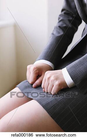 Businesswoman clenching fists on knees View Large Photo Image Stock Photograph - Businesswoman clenching fists on knees. Fotosearch