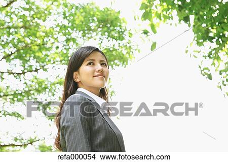 Businesswoman smiling away View Large Photo Image Picture - Businesswoman smiling away. Fotosearch