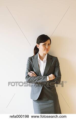 Stock Photo - Businesswoman with crossed arms looking at camera. Fotosearch