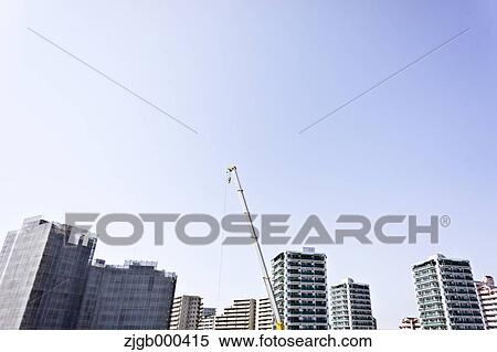 Stock Photography - Condominium units and construction crane. Fotosearch