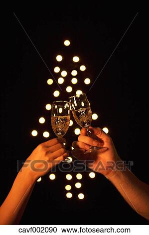 Stock Image - Couple cheering with champagne. Fotosearch