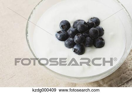 Stock Photo - Cup of yogurt and blueberries. Fotosearch