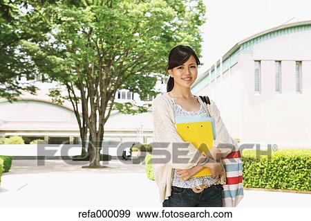 Female college student in a campus smiling at camera View Large Photo Image Stock Photo - Female college student in a campus smiling at camera. Fotosearch