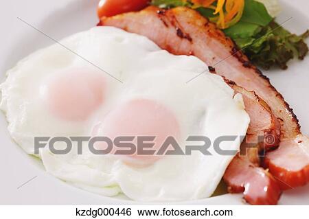 Stock Photograph - Fried eggs and bacon. Fotosearch