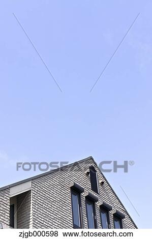 Stock Photo - House rooftop and blue sky. Fotosearch