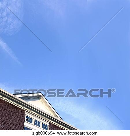 Picture - House rooftop and blue sky with clouds. Fotosearch