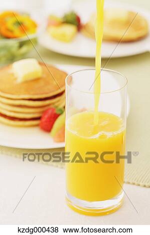Orange juice and pancakes View Large Photo Image Stock Photo - Orange juice and pancakes. Fotosearch