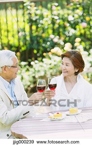 Senior couple cheering with red wine View Large Photo Image Stock Photo - Senior couple cheering with red wine. Fotosearch