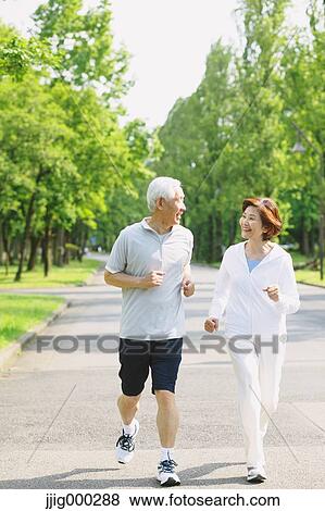 Senior couple jogging in a park View Large Photo Image Stock Photo - Senior couple jogging in a park. Fotosearch