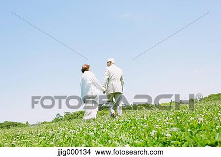 Senior couple on grassland holding hands View Large Photo Image Picture - Senior couple on grassland holding hands. Fotosearch