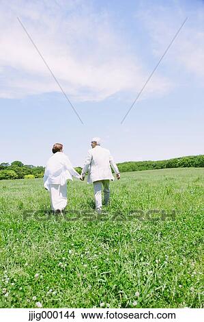 Senior couple on grassland holding hands View Large Photo Image Picture - Senior couple on grassland holding hands. Fotosearch