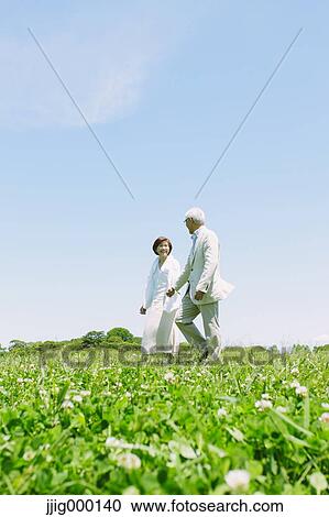 Senior couple on grassland holding hands View Large Photo Image Stock Image - Senior couple on grassland holding hands. Fotosearch