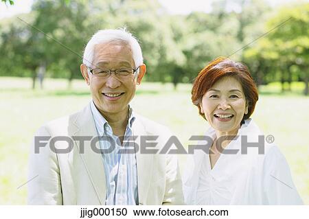 Stock Image - Senior couple smiling at camera. Fotosearch